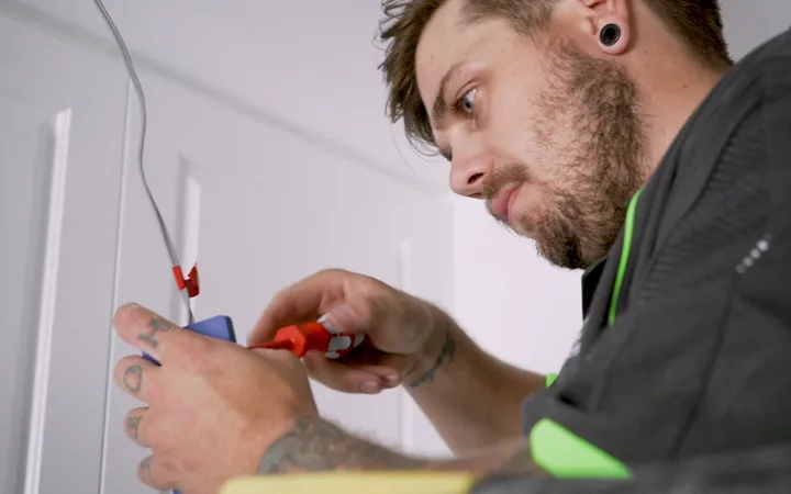 Electrician terminating a cable on site