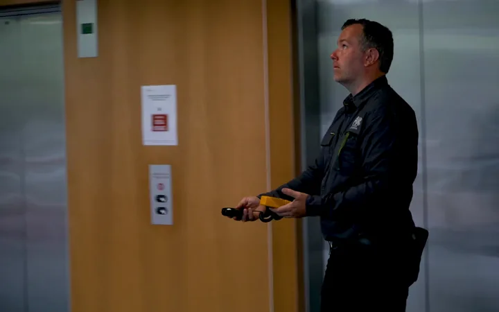 Electrician testing a control panel in a commercial building