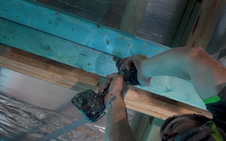 Electrician fixing services to structural framing
