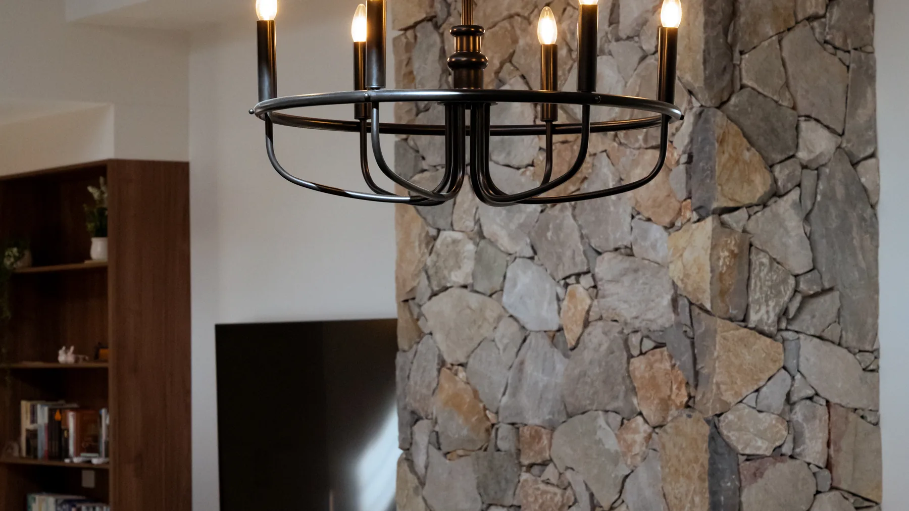 Feature chandelier lit above a dining table