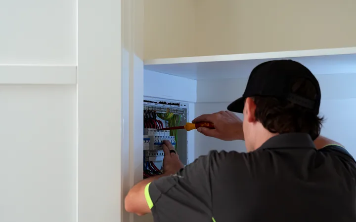 Electrician inspecting a switchboard