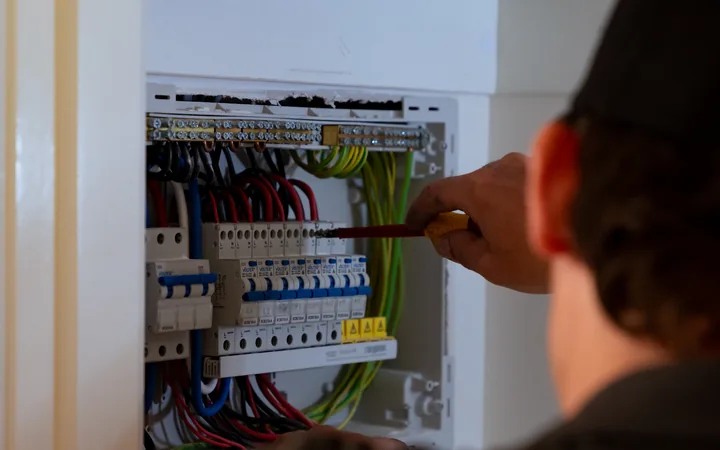 Electrician wiring a switchboard