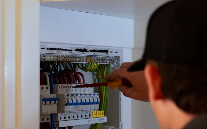 Electrician testing the completed switchboard